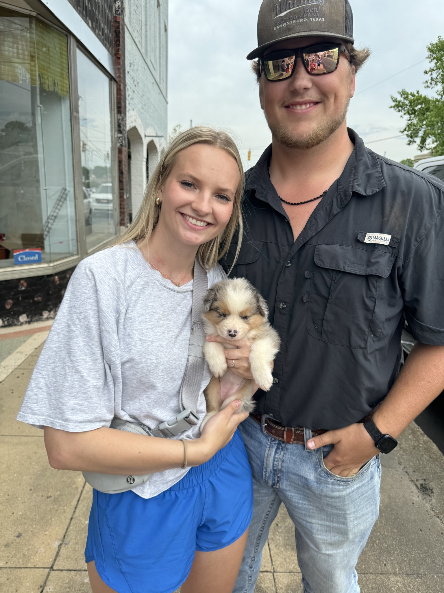 Millie cuddled by her new family outdoors